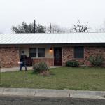 After Picture with a new 1" Standing Seam Mechanical Lock, 24 Gauge metal roof in the color Sandstone and new 6" K-Style Seamless Gutters in the color Light Bronze.